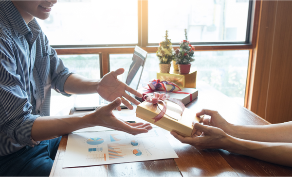 a-woman-handing-a-gift-to-a-man