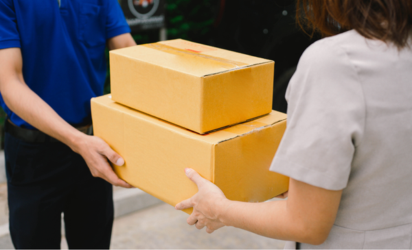 a-man-handing-over-packages-to-a-woman