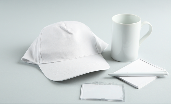 a-white-cap-with-white-mug-white-id-case-white-pen-and-notepad