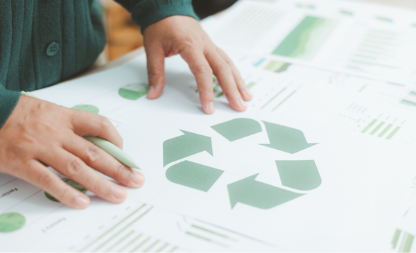 a-hand-touching-a-recycle-symbol
